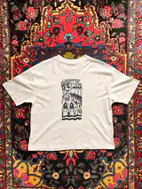 Detail of the Misguided Care print on a off-white T-shirt