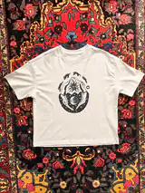 Detail of the In Cycles print on a off-white T-shirt