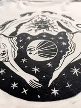 Detail of the In Cycles print on a off-white T-shirt