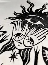 Detail of the New Sight print on a off-white T-shirt