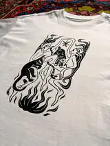 Detail of the Sacred Dance print on a off-white T-shirt