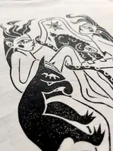 Detail of the Sacred Dance print on a off-white T-shirt