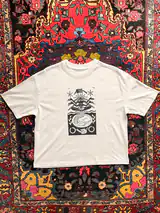 Detail of the Seed of Change print on a off-white T-shirt